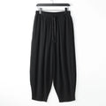 Loose fit linen harem pants for men with an ankle tie, shown in a neutral colour.