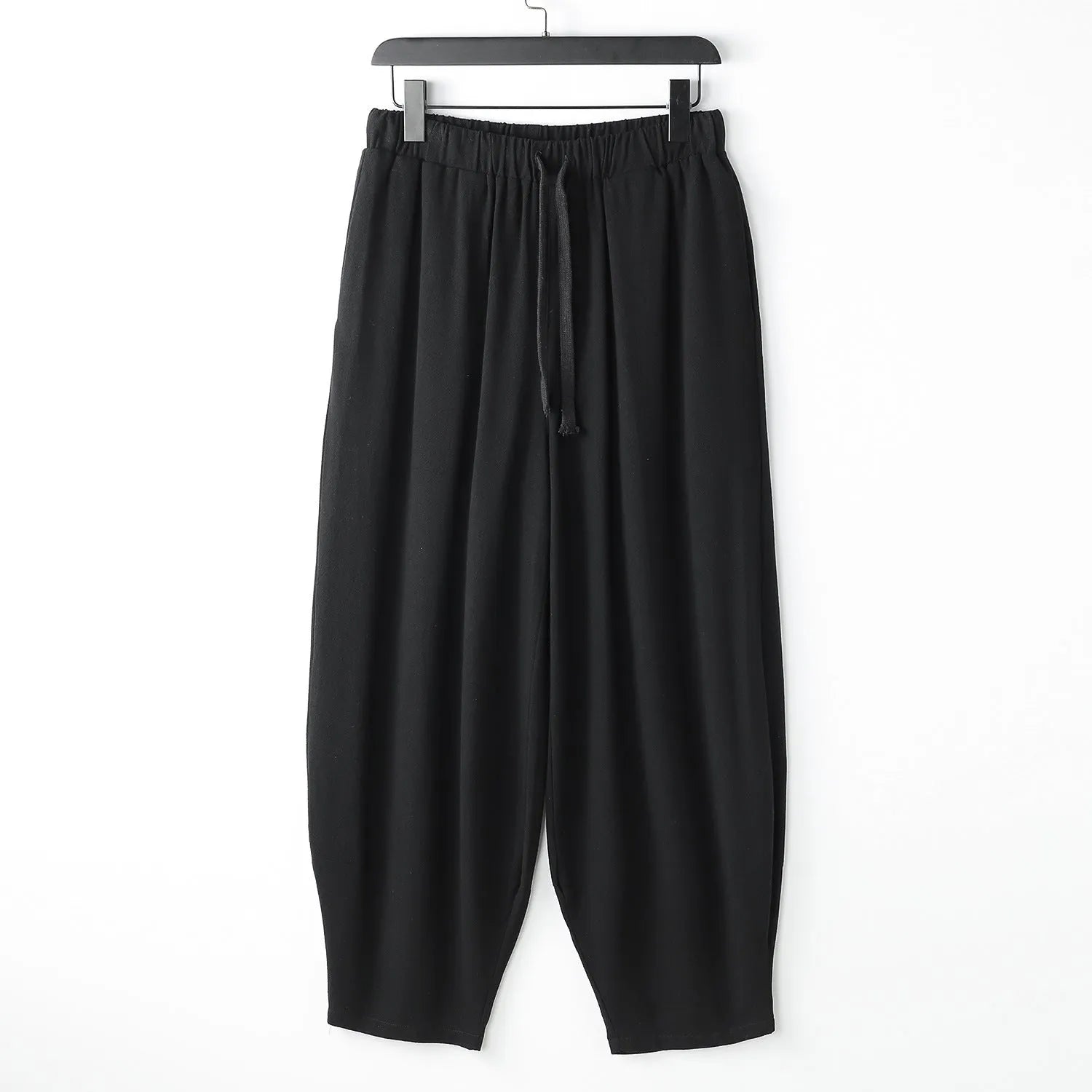 Loose fit linen harem pants for men with an ankle tie, shown in a neutral colour.
