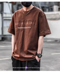 Men's short sleeve simple printed top in combed cotton available in brown, black, and white