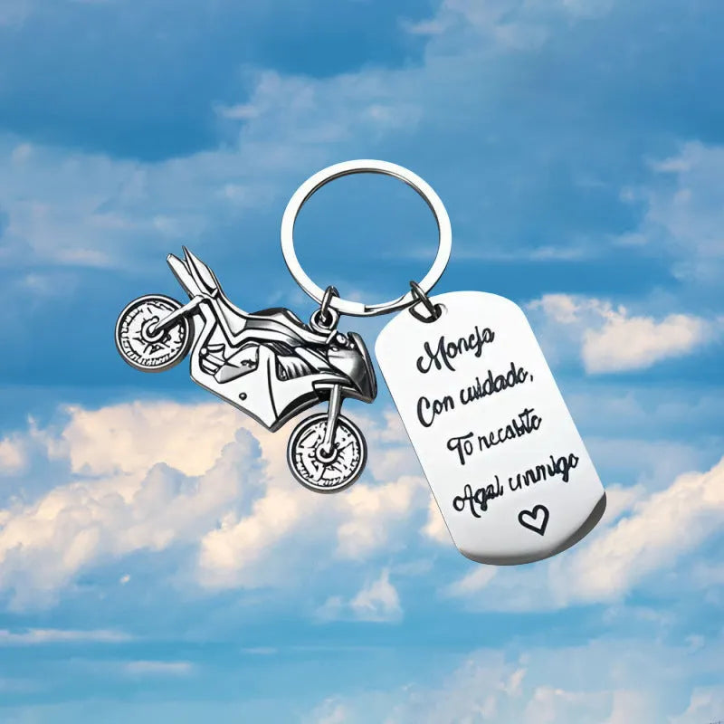 Stainless steel motorcycle-themed keychain with minimalist design, shown with its flannel storage bag.
