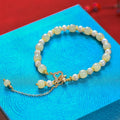 Women's Hetian jade bracelet with pearl pendant and electroplated gold alloy metal in Chinese style