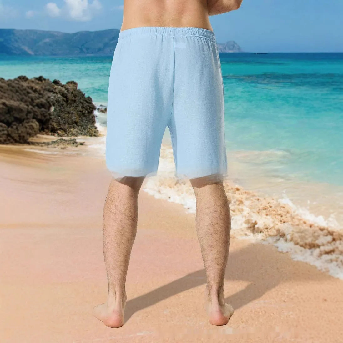 Man wearing blue colour block print loose casual shorts with lace-up waist.