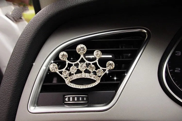 Alloy car fragrance clip with decorative charm attached to car air vent