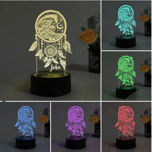 Modern acrylic dream catcher table lamp with colourful LED lights and a remote control on a wooden surface.