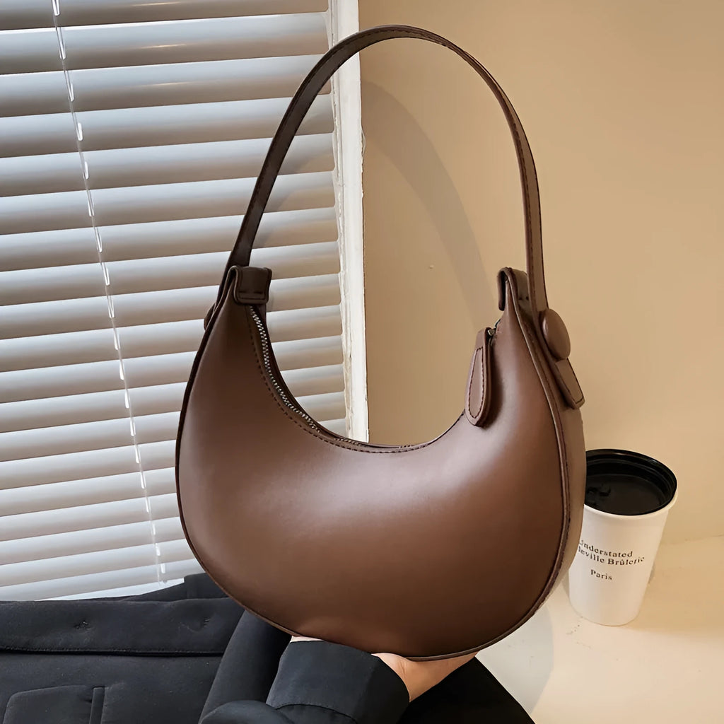 Retro dumpling-shaped women's shoulder bag in PU leather with a front pocket.