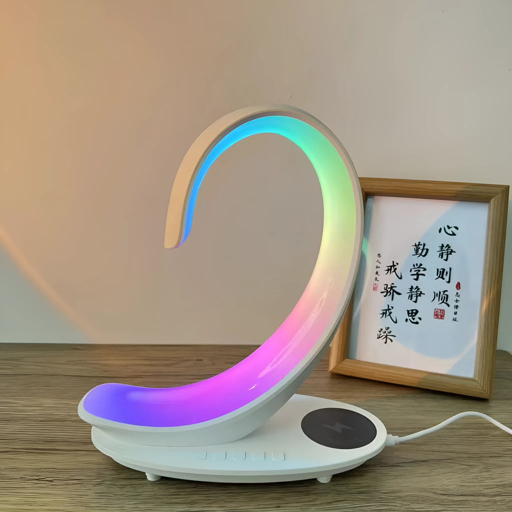 White swan-shaped desktop device with wireless charging, Bluetooth speaker, and colourful mood lighting functions