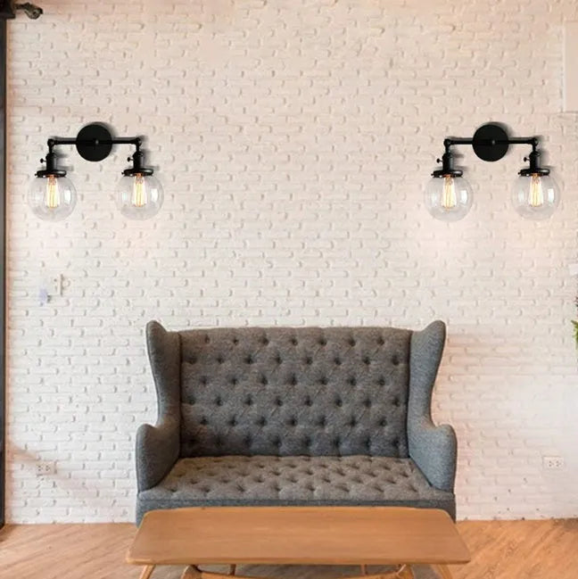 Double headed industrial wall lamp with spherical glass shades, iron black finish, 15x12x24cm