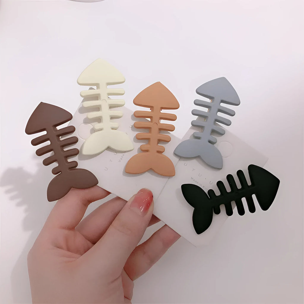 A minimalist fishbone design duckbill clip hair barrette in a muted candy colour.