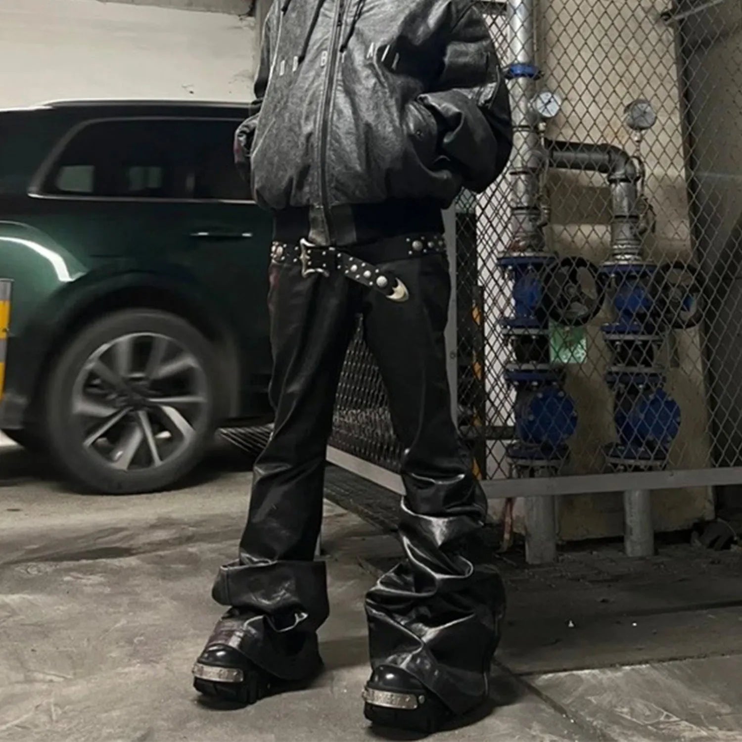 Black shiny patent leather skinny jeans with a straight-leg cut and mid waist