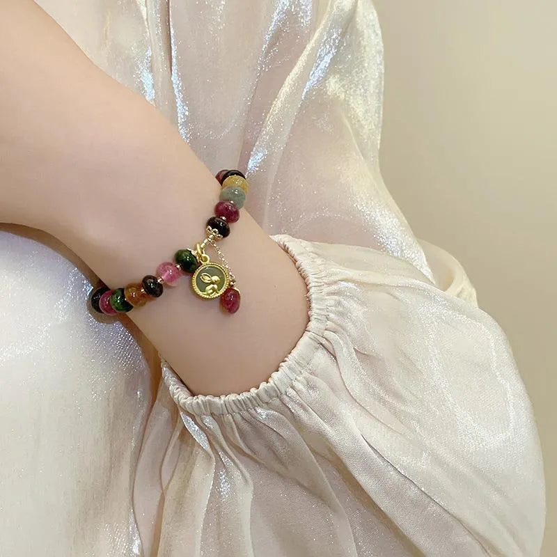 Colourful tourmaline bracelet with rabbit pendant and round abacus beads on wrist