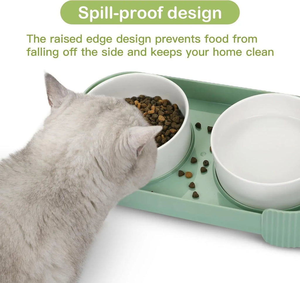 Green ceramic raised cat bowl set with two bowls on a tilted stand and non-slip base.