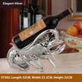 Lobster-shaped decorative wine rack ornament in rose gold or silver holding wine bottle