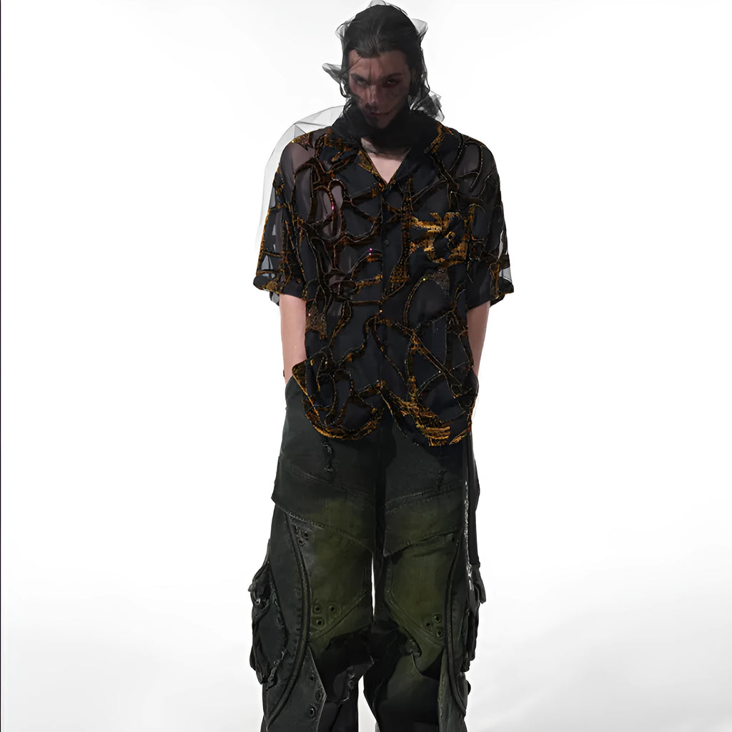 Man's black and grey snake pattern short-sleeved shirt with loose fit and lapel collar.