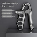 Adjustable spring grip trainer with electronic counter display in orange, red, or grey colour.