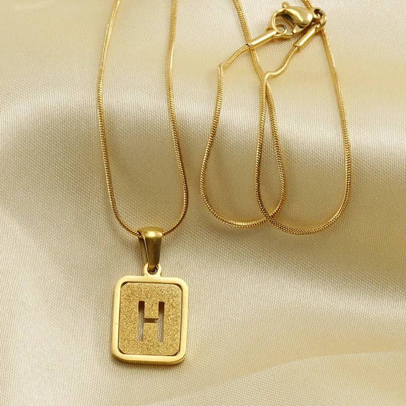 Alphabet necklace with square hollow-out letter pendant in titanium steel, gold or silver electroplated small snake chain