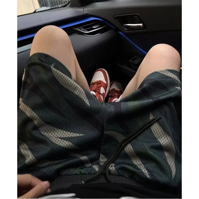 Men's camouflage pattern straight-leg shorts in a cotton blend fabric on a neutral background.