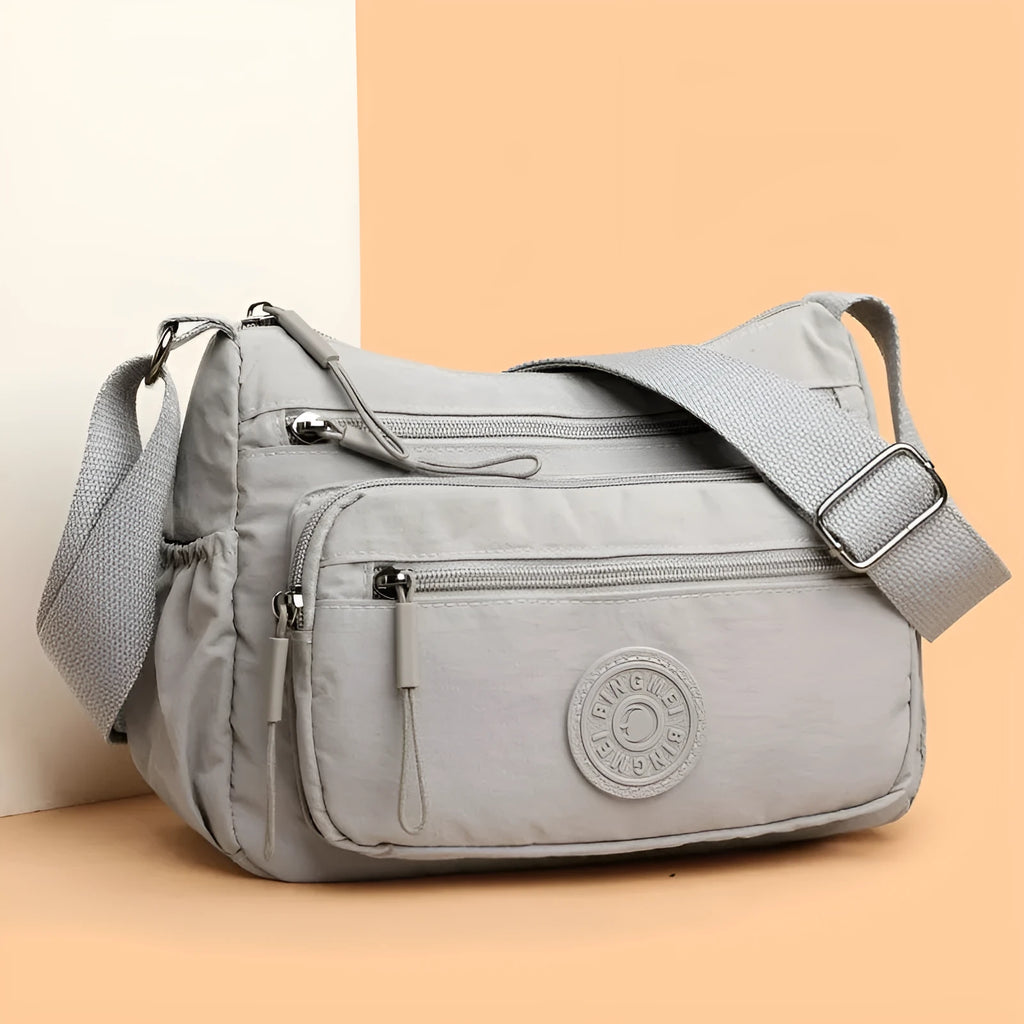 Water-repellent nylon crossbody bag with three-dimensional pocket in black, grey or red
