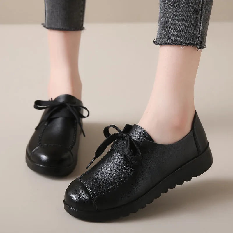 Women's black flat work shoes with microfiber upper, round toe, front lacing and anti-slip polyurethane sole