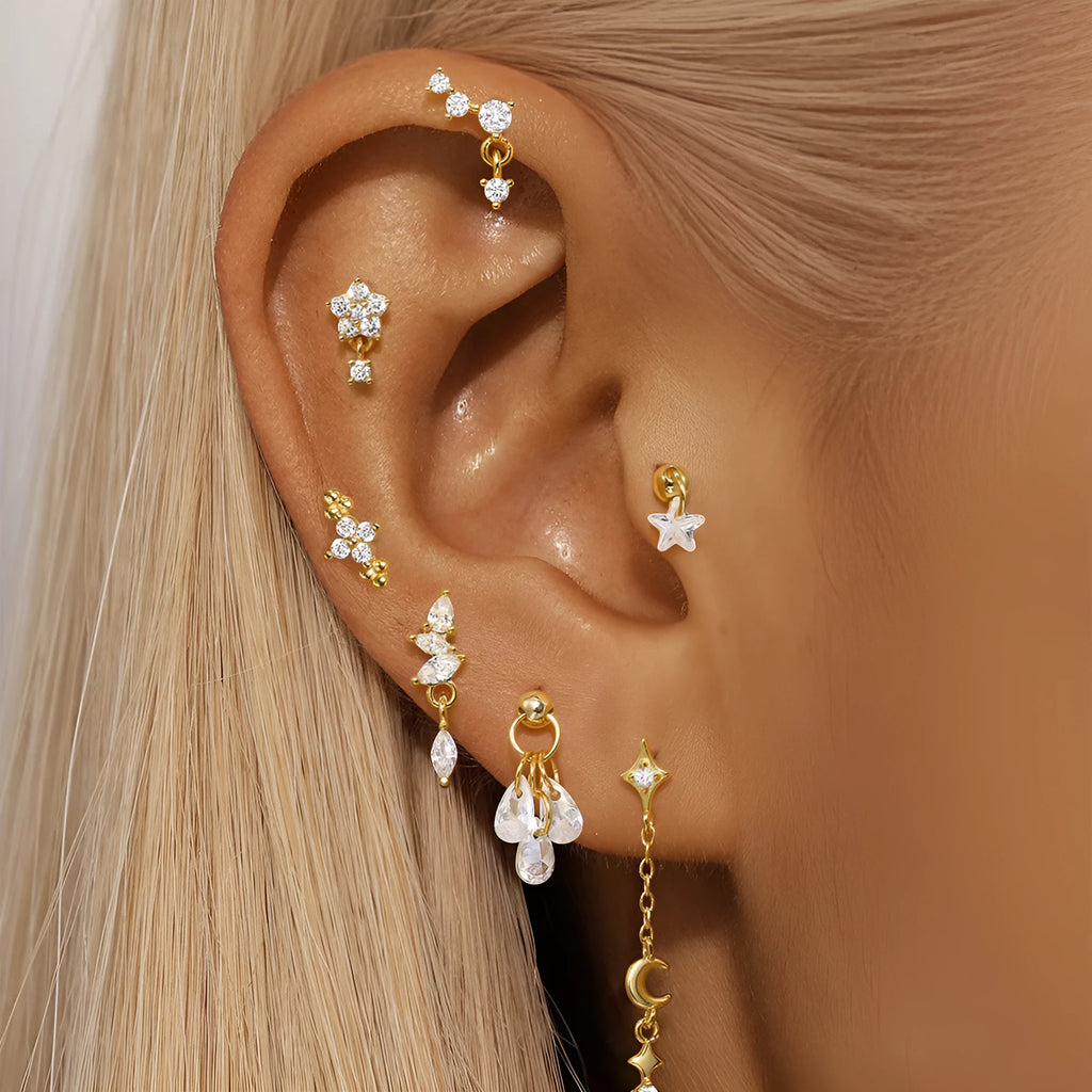 S925 sterling silver moon earring with a small diamond set in a star design on a gold-toned background.
