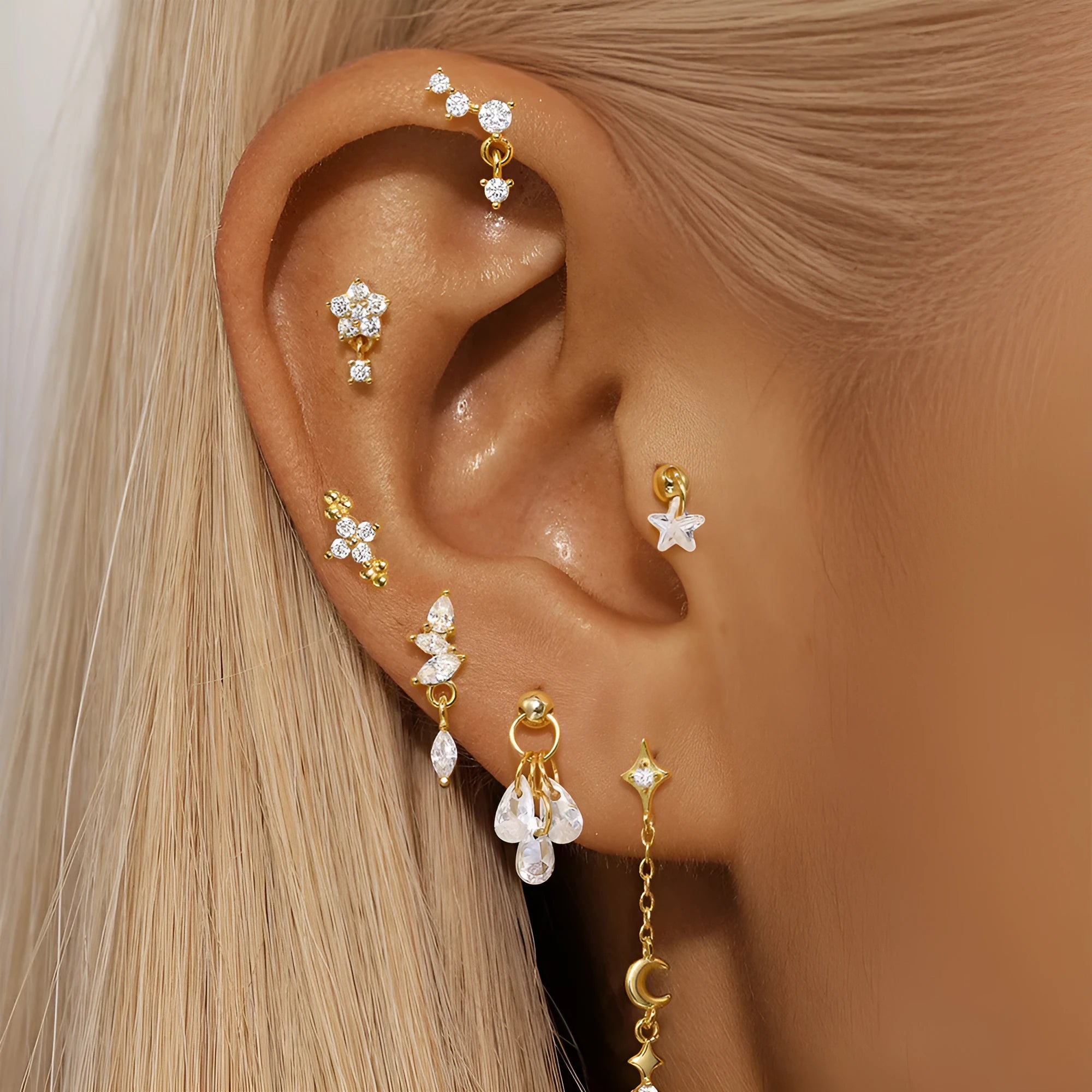 S925 sterling silver moon earring with a small diamond set in a star design on a gold-toned background.