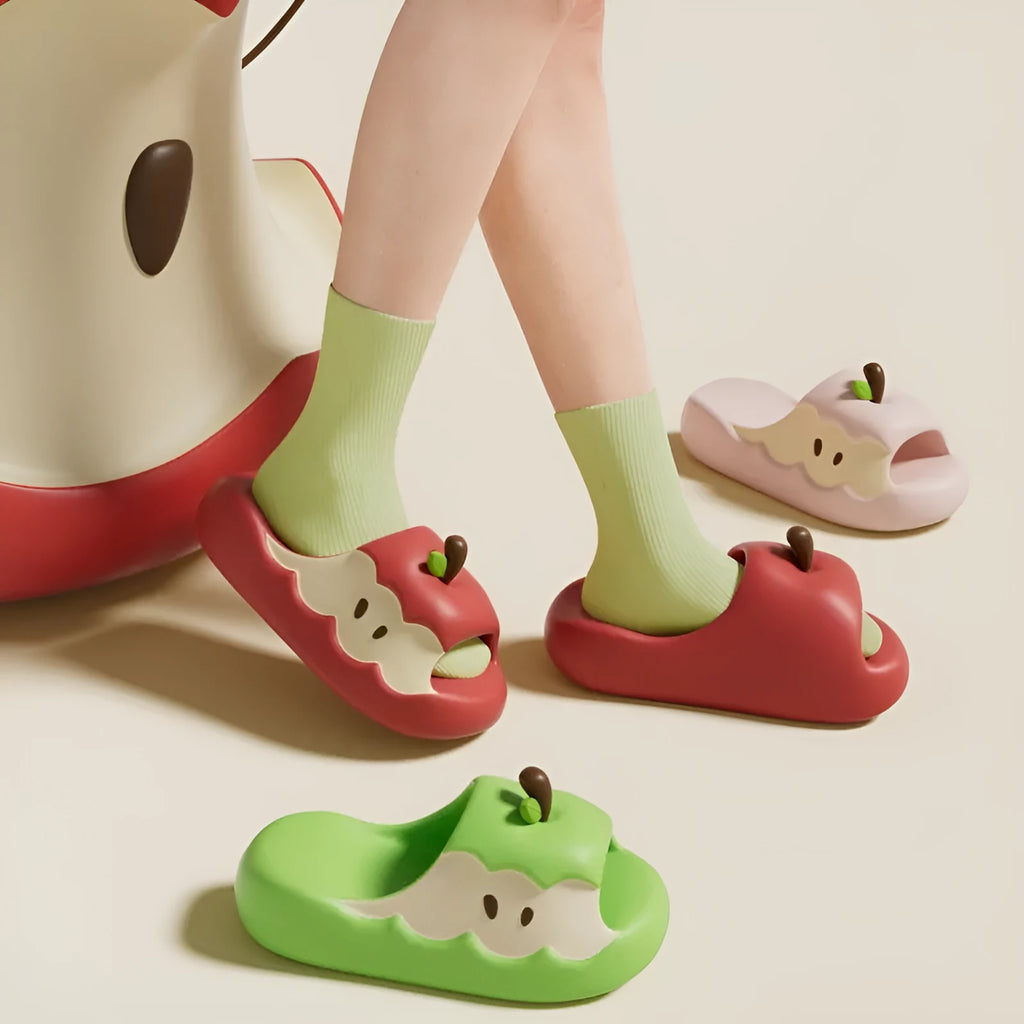 Pair of fruit-themed cartoon EVA flip flop sandals for parent-child home wear on a light background.