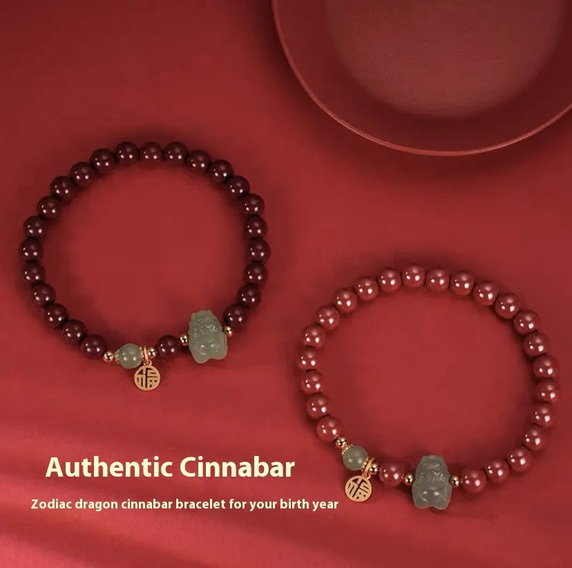 Natural Hetian Jade bracelet with cinnabar detail and zodiac charm on wrist.