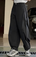 High-waisted black wide-leg casual trousers with a front pleat and elasticated waistband.