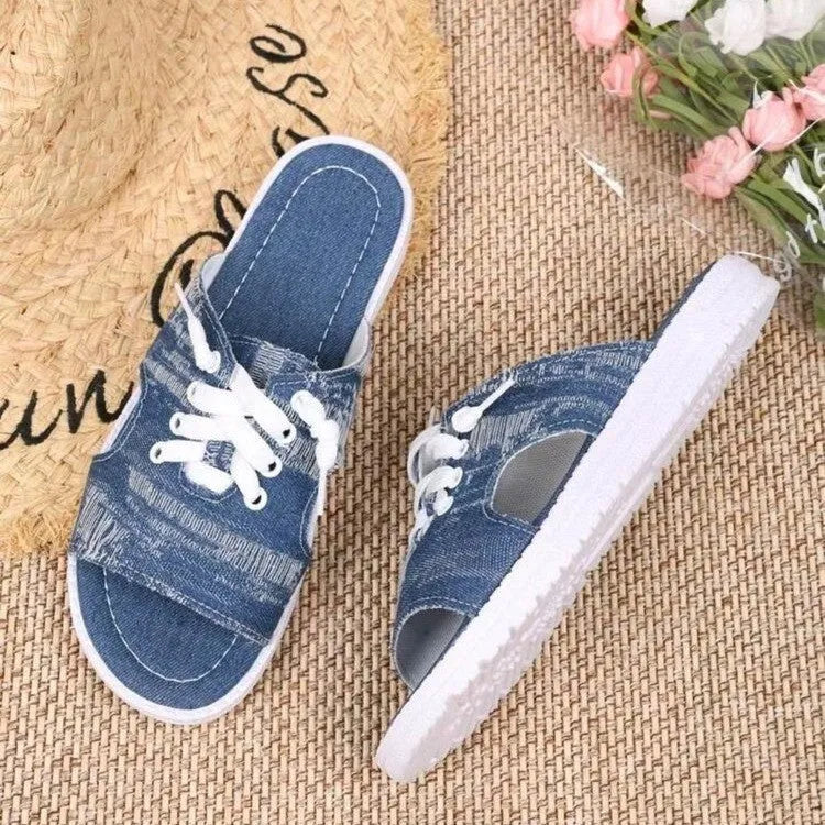 Blue Roman-style women's flat canvas slippers with a cloth upper and rubber sole.