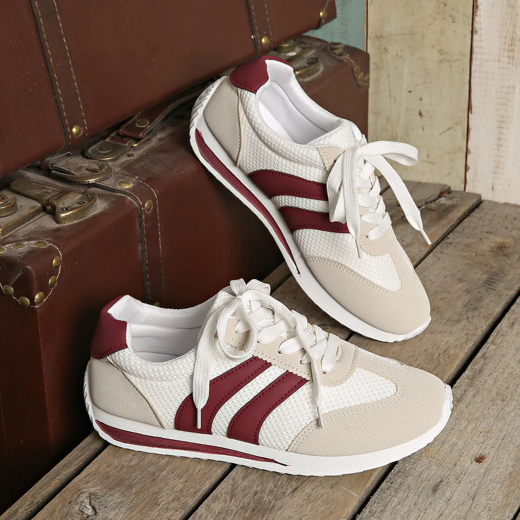 Wine red casual sneakers with cross straps over a breathable mesh and synthetic leather upper.