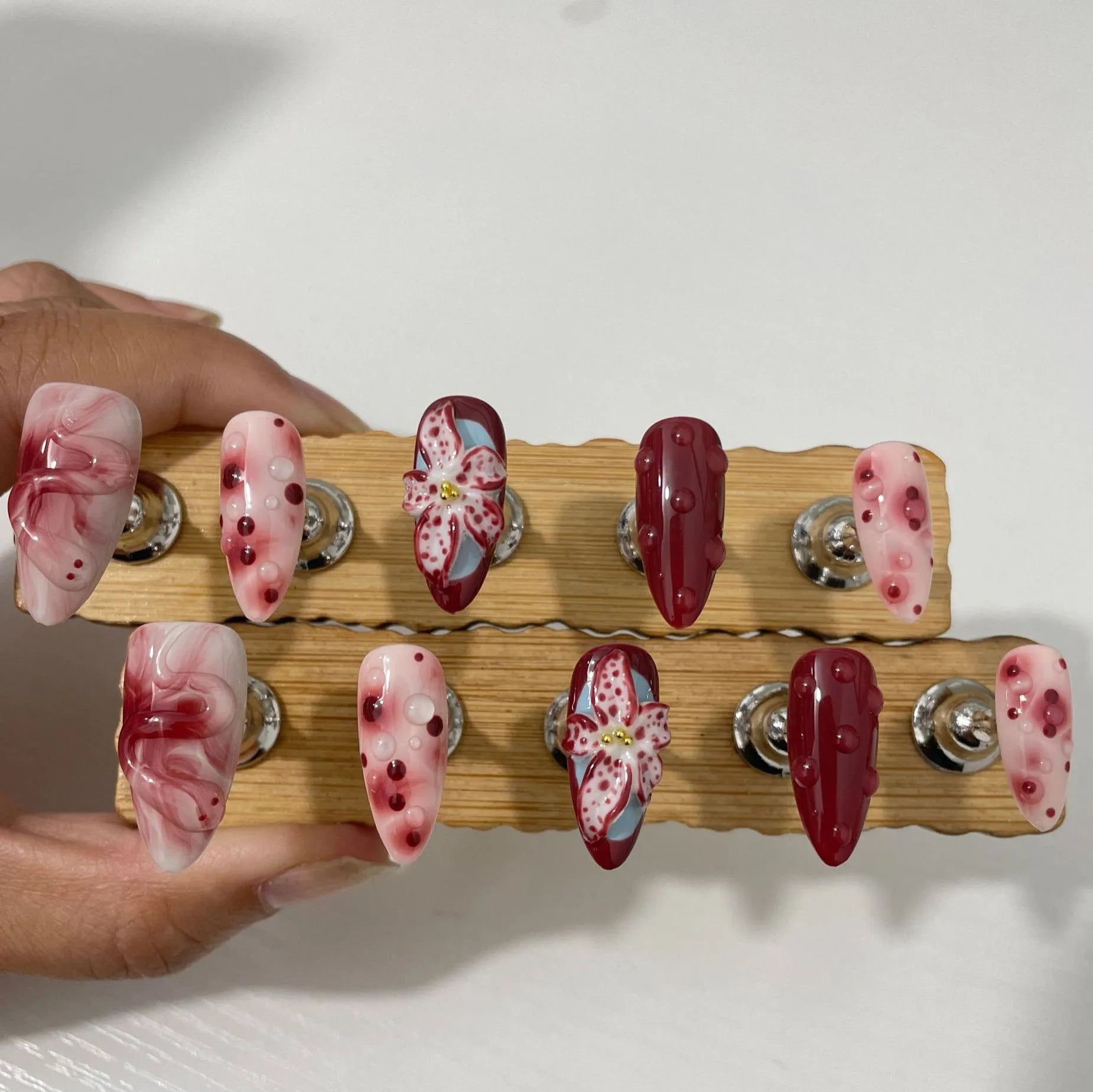 Hand-painted three-dimensional carved almond manicure nails with floral patterns in medium length