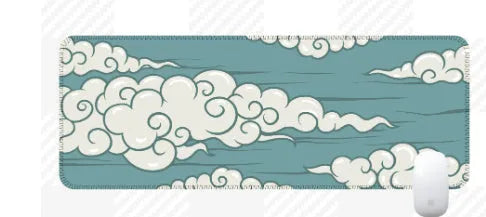 Large cloud pattern desk mat with natural rubber non-slip base on a wooden desk