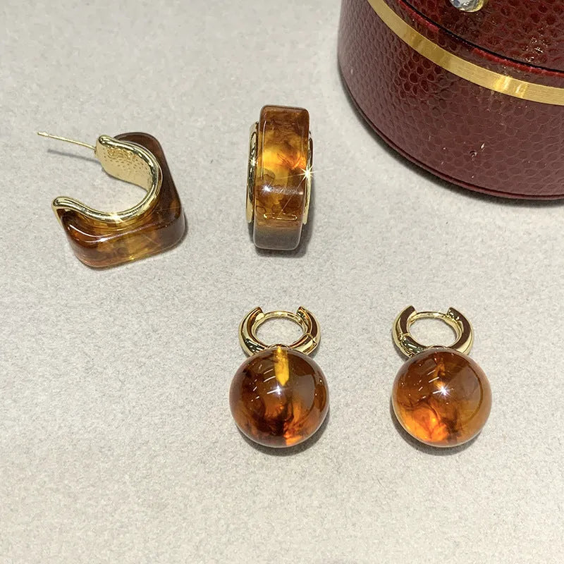 Simple Retro amber resin drop dangle earrings Style1, lightweight, approx 3.5 cm length, warm translucent colour, on neutral background