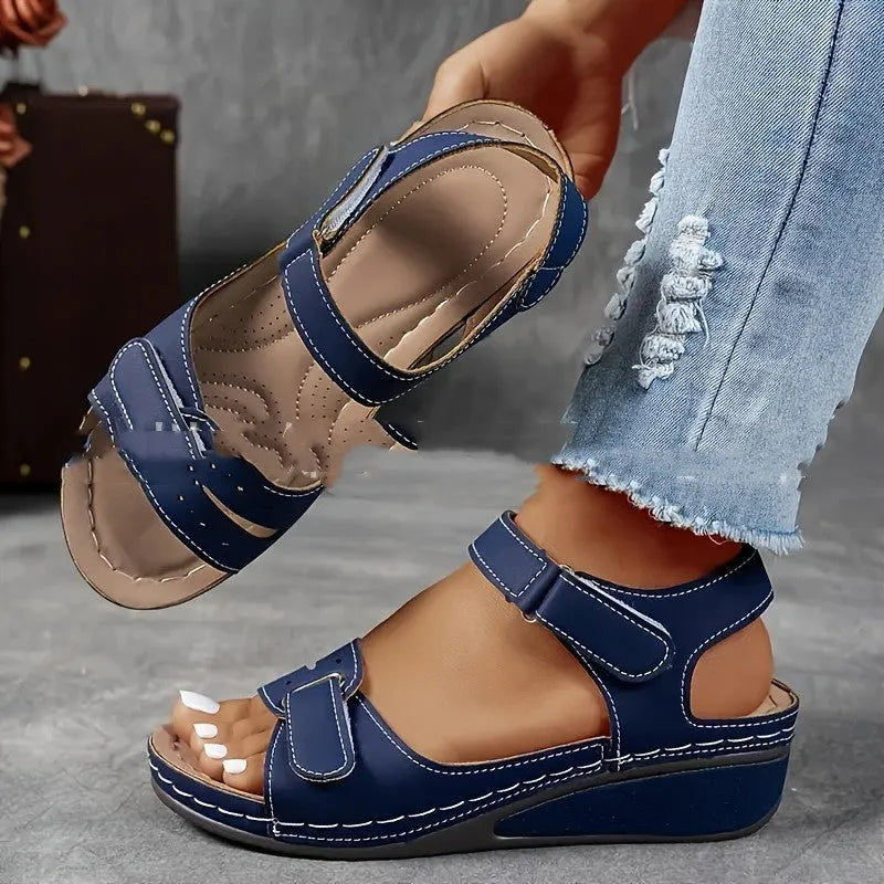 Beige wide fit sandals with thick composite sole and adjustable Velcro straps on a white background.