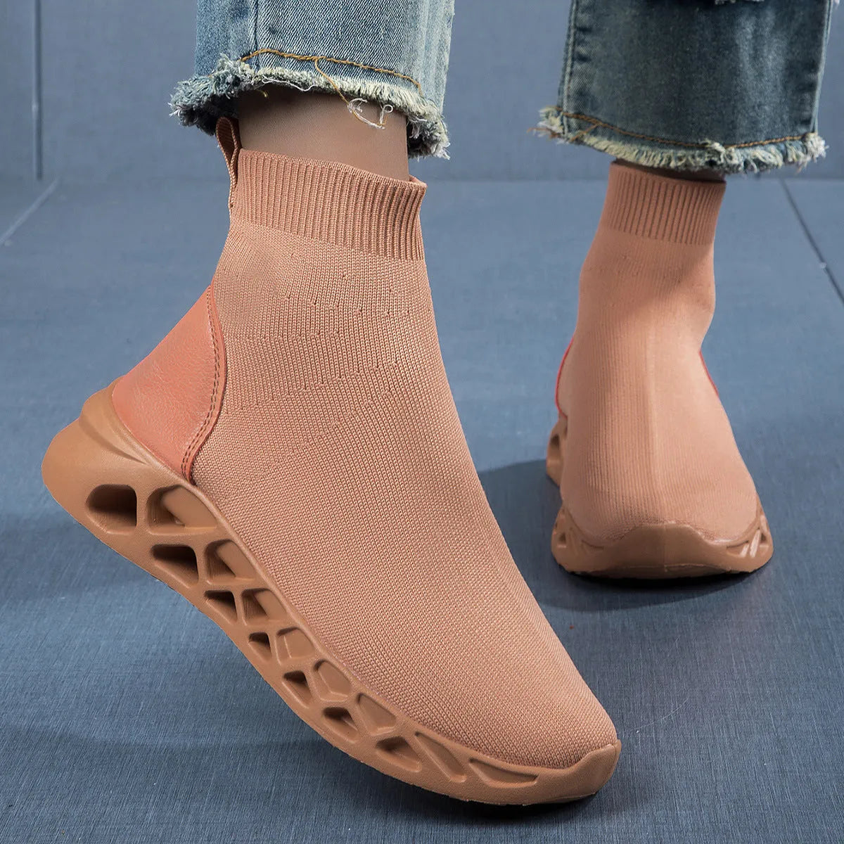 Women's black mesh slip-on casual shoe with a low-top, sock-like ankle design and flat sole.