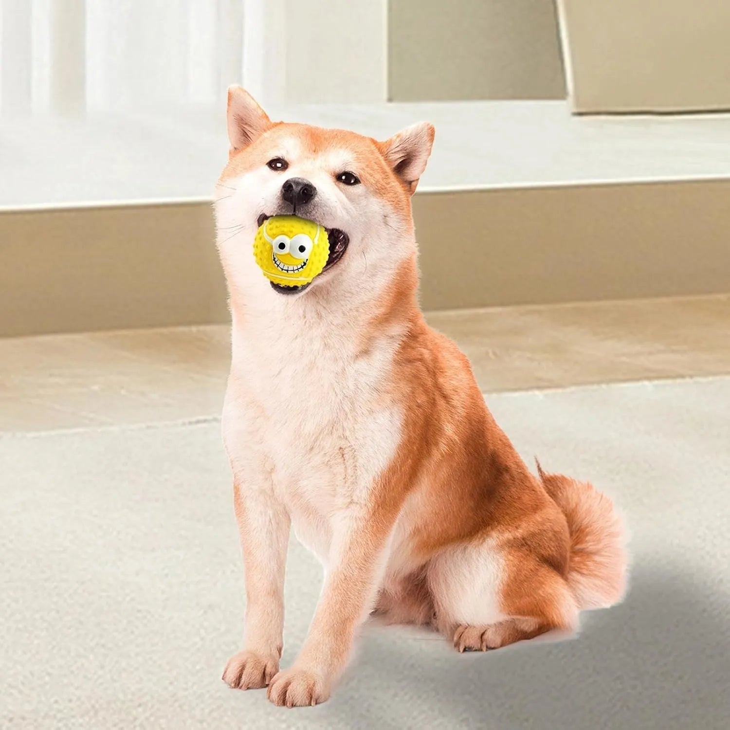 Green, orange, and yellow smile face latex squeaky dog ball toy.