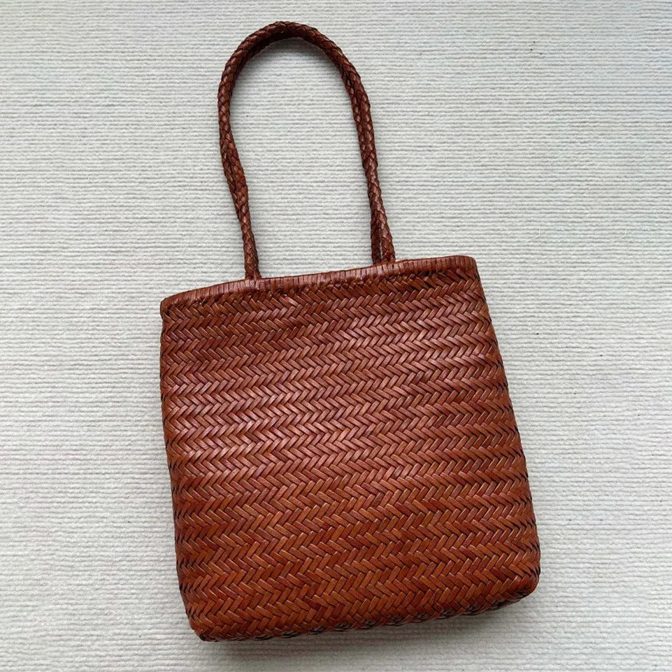Brown woven genuine cowhide leather tote bag with a front pocket.