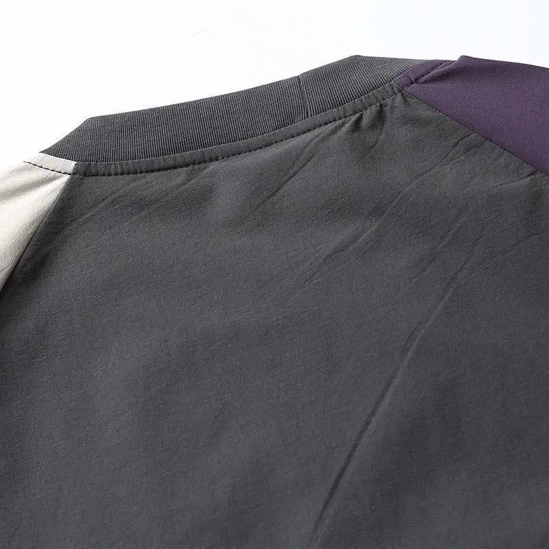 Dark grey loose fit T-shirt with contrast colour raglan sleeves on a hanger