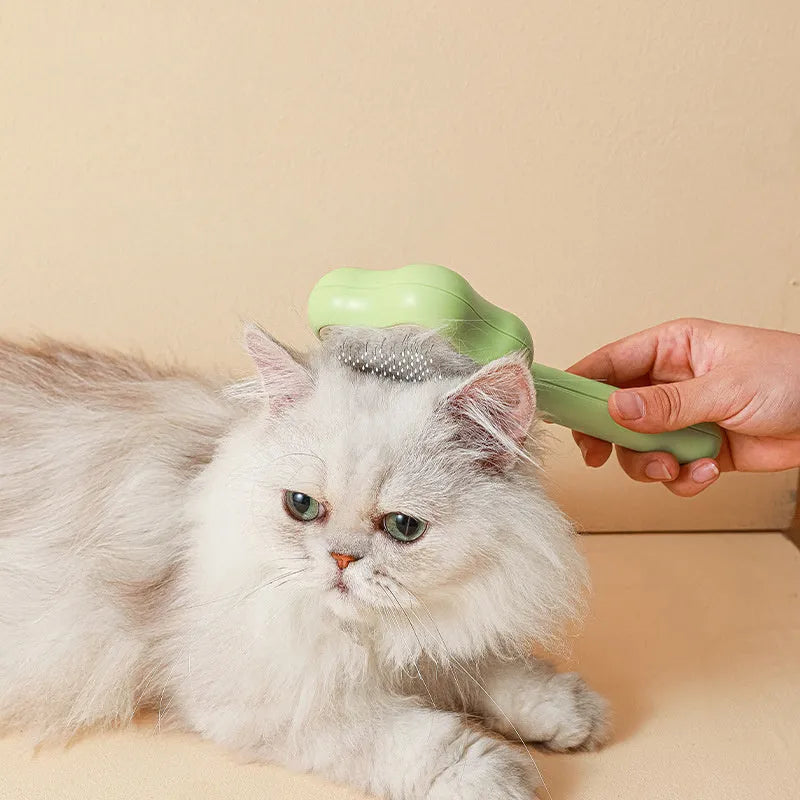 Green self-cleaning cat comb with stainless steel needle teeth and 20 cm handle