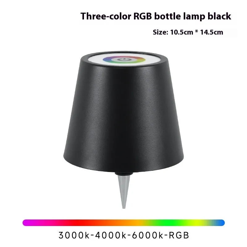 Plug-in wine bottle lamp with RGB tricolour dimming in wrought iron black finish on a table