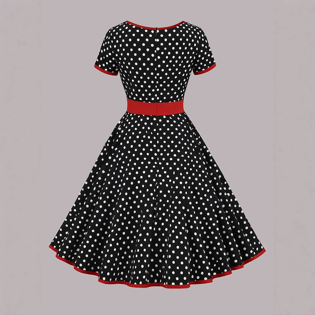 Multicolour polka dot pleated dress with square collar and short sleeves on a hanger.