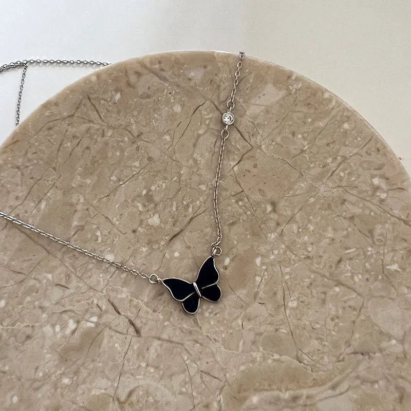 S925 silver butterfly necklace with white silver colour-change pendant on display