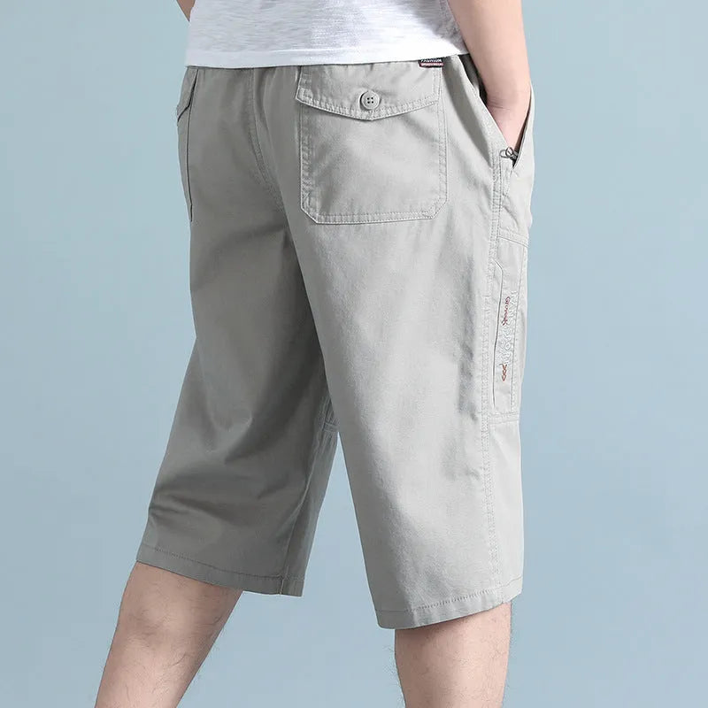 Men's light grey cotton sports pants with straight cut and cropped length on hanger