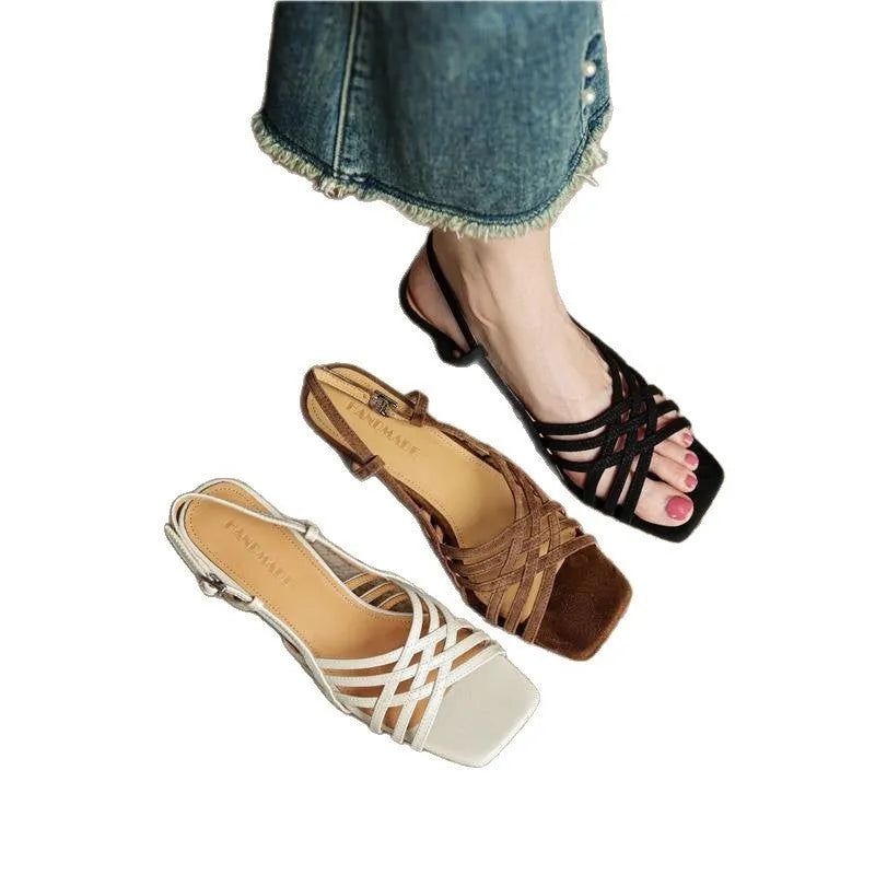 Retro light brown high heel sandals with thin cross straps and an ankle buckle on a square toe.
