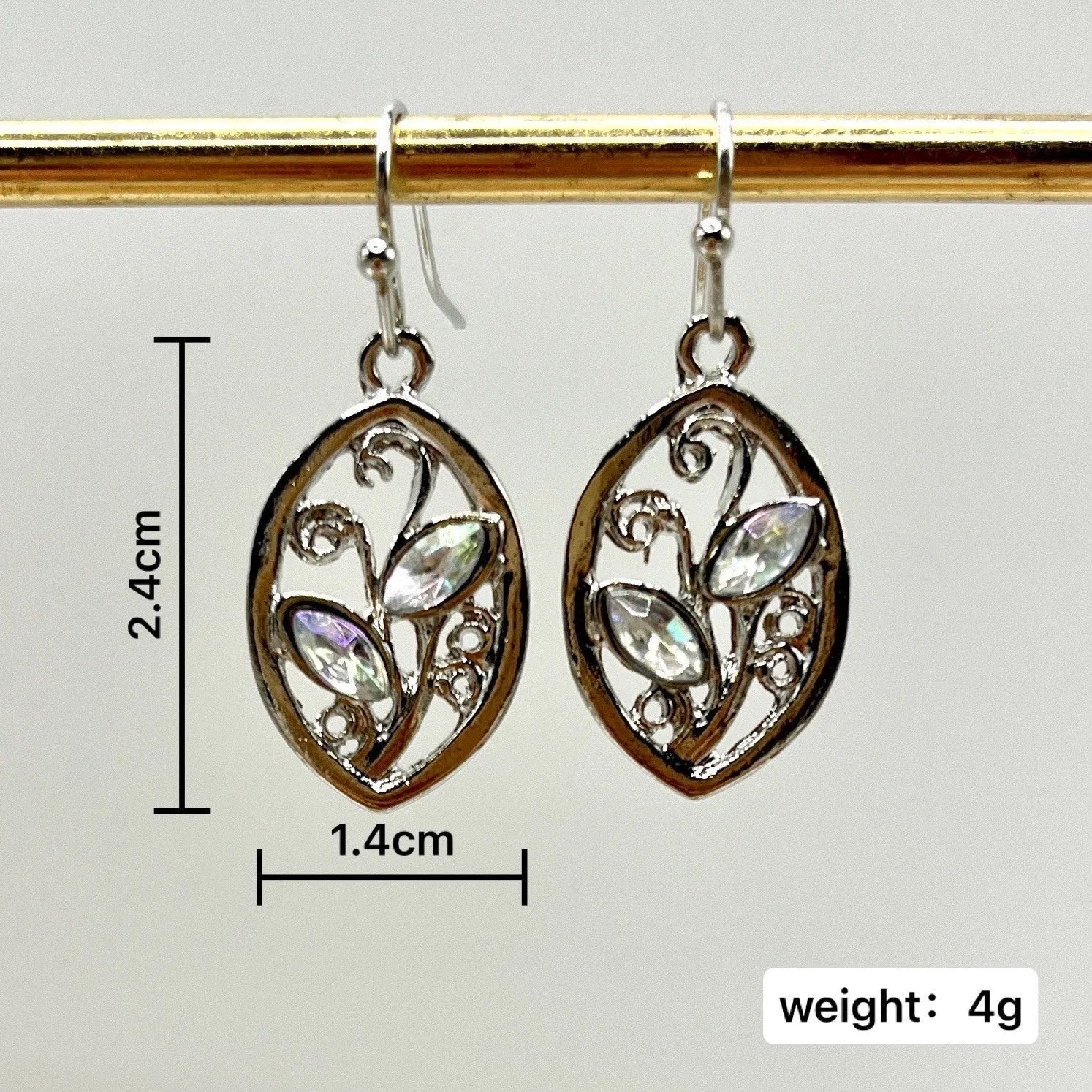 Silver alloy leaf-shaped earrings with an embedded colourful moonstone centrepiece.