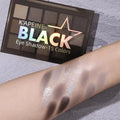 15-colour eyeshadow palette with matte and shimmer pans in grey, black, brown, and blue shades.