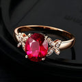 Women's copper butterfly ring with heart shape and rose gold finish showing red gemstone accent option