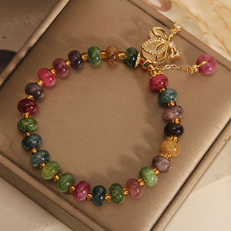 Colourful tourmaline bead and butterfly charm on women's alloy bracelet
