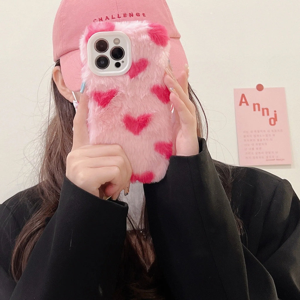 Pink silicone iPhone case featuring a Love Plush cartoon design on the back.