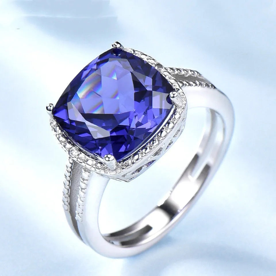 Blue tanzanite stone set in sterling silver women's ring with alloy accessory
