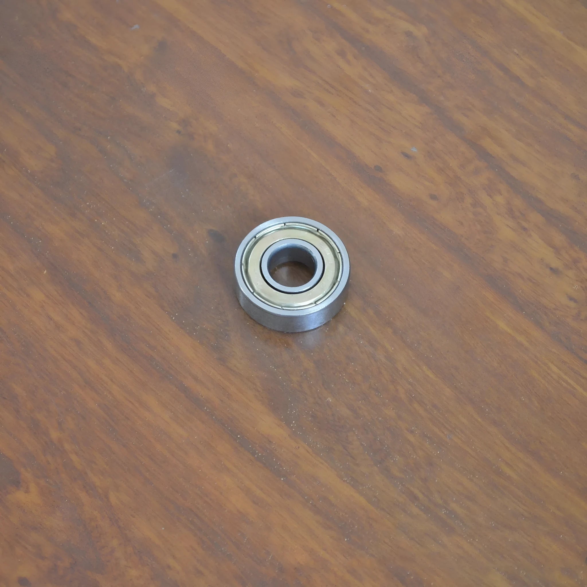 6000z carbon steel ball bearing showing 10mm bore, 26mm outer diameter, 8mm width, and iron cage.